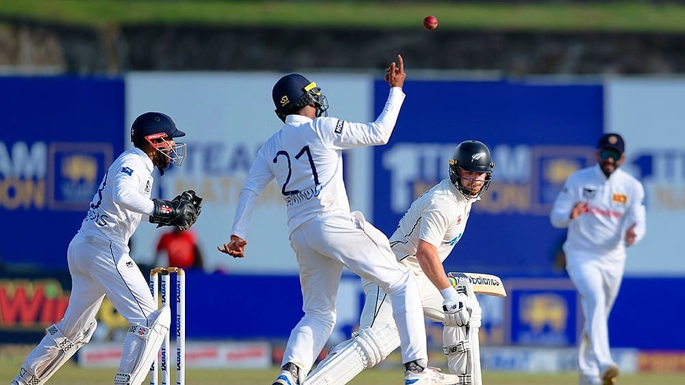 | Photo: AP/Viraj Kothalawala : Sri Lanka vs New Zealand 1st Test: Sri Lanka's Kamindu Mendis celebrates after taking the catch of New Zealand's Glenn Phillips