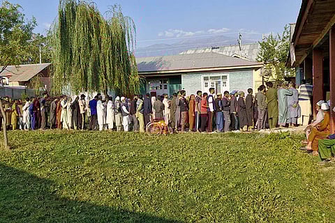 J&K Assembly elections, 2nd Phase voting: Voters stand in a queue to cast votes at a polling center at Khan Sahib in Budgam district