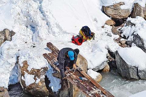 Worker repairing a bridge damaged in Kedarnath disaster