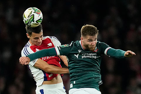 EFL Cup, Arsenal vs Bolton Wanderers: Arsenal's Jakub Kiwior, left, fights for a ball with Bolton's John McAtee