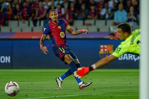 La Liga 2024-25, Barcelona vs Getafe: Barcelona's Raphinha, left, kicks the ball