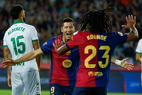 La Liga 2024-25, Barcelona vs Getafe: Barcelona's Robert Lewandowski, center, celebrates with Barcelona's Jules Kounde, front, after scoring the opening goal