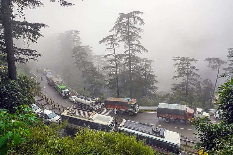 Vehicles stuck in a jam after Tree uprooted due to heavy rains in Shimla
