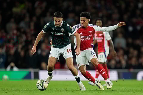 EFL Cup, Arsenal vs Bolton Wanderers: Bolton's Aaron Collins, left, is challenged by Arsenal's Ethan Nwaneri