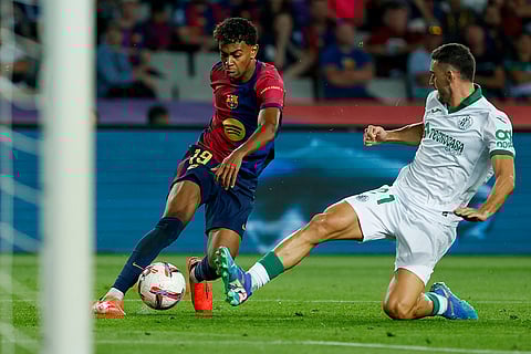 La Liga 2024-25, Barcelona vs Getafe: Barcelona's Lamine Yamal, left, duels for the ball with Getafe's Juan Iglesias