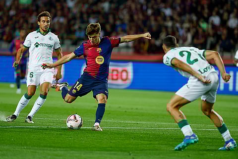 La Liga 2024-25, Barcelona vs Getafe: Getafe's Juan Iglesias, right, tries to block a shot from Barcelona's Pablo Torre