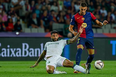 La Liga 2024-25, Barcelona vs Getafe: Barcelona's Ferran Torres, right, duels for the ball with Getafe's Omar Alderete