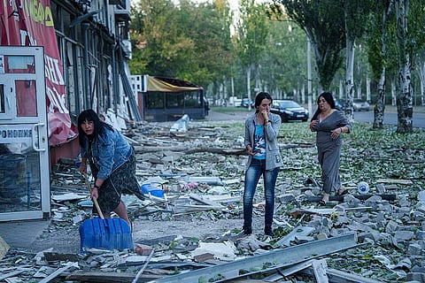 Russia Ukraine War: People clear the rubble in a front of a residential building in Kramatorsk