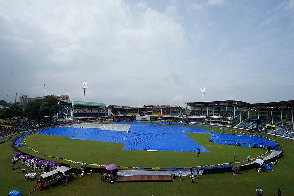 | Photo: AP/Ajit Solanki : India Vs Bangladesh, 2nd Test Day 1: The playing area of the Green Park stadium is partially covered after a light shower