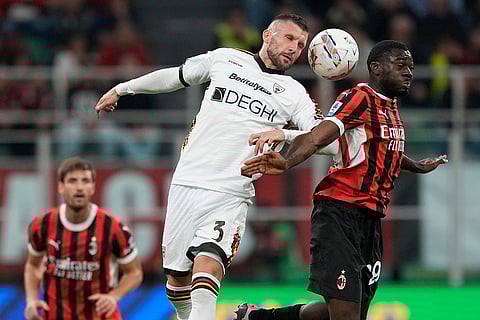 Serie A 2024-25, AC Milan vs Lecce: Lecce's Ante Rebic. left, and AC Milan's Youssouf Fofana jump for the ball