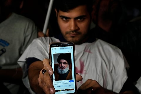 Israel-Hezbollah War: An Iranian demonstrator shows a portrait Hezbollah leader Hassan Nasrallah during a demonstration