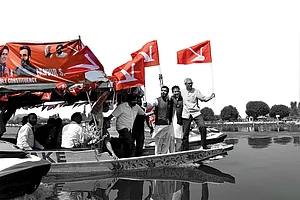 Photo: Yasir Iqbal : Smooth Sailing or Sinking?: Omar Abdullah with his party members during a boat rally in Srinagar