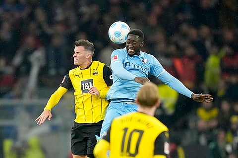German Bundesliga 2024-25, Borussia Dortmund vs VfL Bochum: Bochum's Ibrahima Sissoko jumps for the ball with Dortmund's Pascal Gross