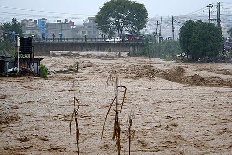 Nepal Floods: People watch the turbulent waters of Bagmati River from a bridge