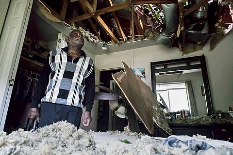 Hurricane Helene: McKinley Moore inspects the damage on his home after a tree fell over