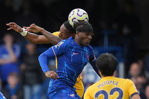 English Premier League 2024-25, Chelsea vs Brighton: Brighton's Pervis Estupinan, left, and Chelsea's Noni Maduekeh go for a header