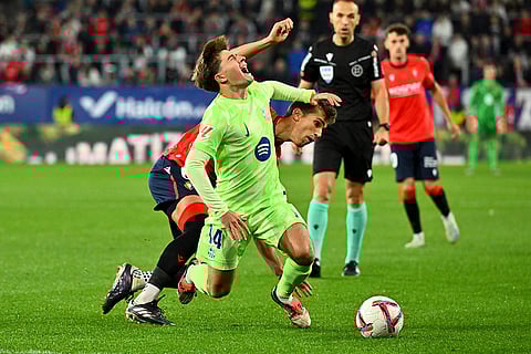 La Liga 2024-25, Osasuna and Barcelona: Barcelona's Pablo Torre is tackled by Osasuna's Lucas Torro