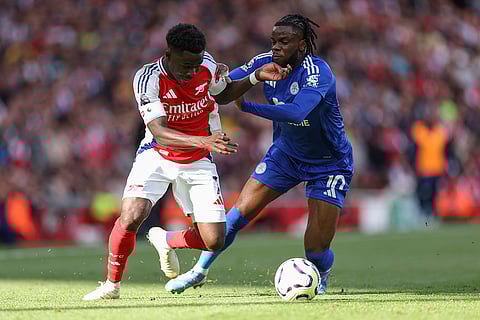 English Premier League 2024-25, Arsenal vs Leicester City: Arsenal's Bukayo Saka, left, challenges for the ball with Leicester's Stephy Mavididi