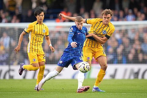 English Premier League 2024-25, Chelsea vs Brighton: Chelsea's Cole Palmer, center, and Brighton's Mats Wieffer, right, vie for the ball