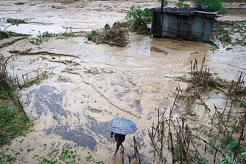 Nepal Floods: A man walks on the shore of the flooded Bagmati River