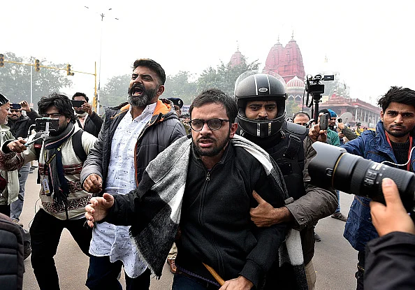 Umar Khalid with police men at the Constitution Club in New Delhi.