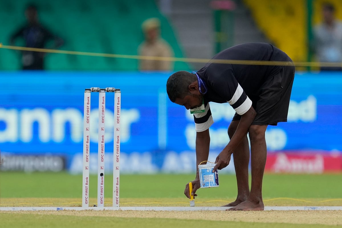 AP : Representative image showing a groundsman marking a pitch ahead of a match.