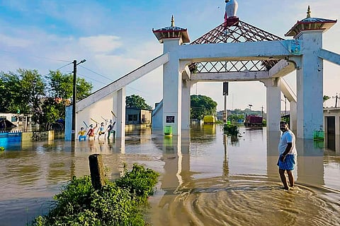 Bihar Floods: A man walks through a flooded area in Sitamarhi