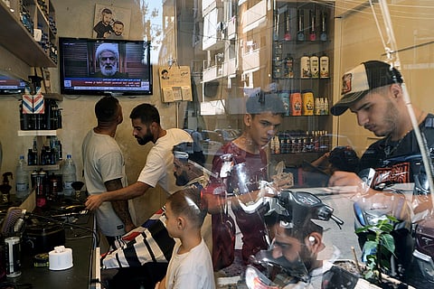 Mideast Tensions: People listen to a speech by Hezbollah's deputy leader Sheik Naim Kassem in Beirut