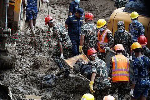 Nepal Floods: Rescue personnel transport the dead body of a victim