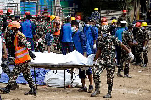 Nepal Floods: Rescue personnel transport the dead body of a victim