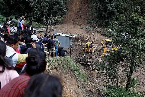 Nepal Floods: People watch earthmovers removing automobile debris