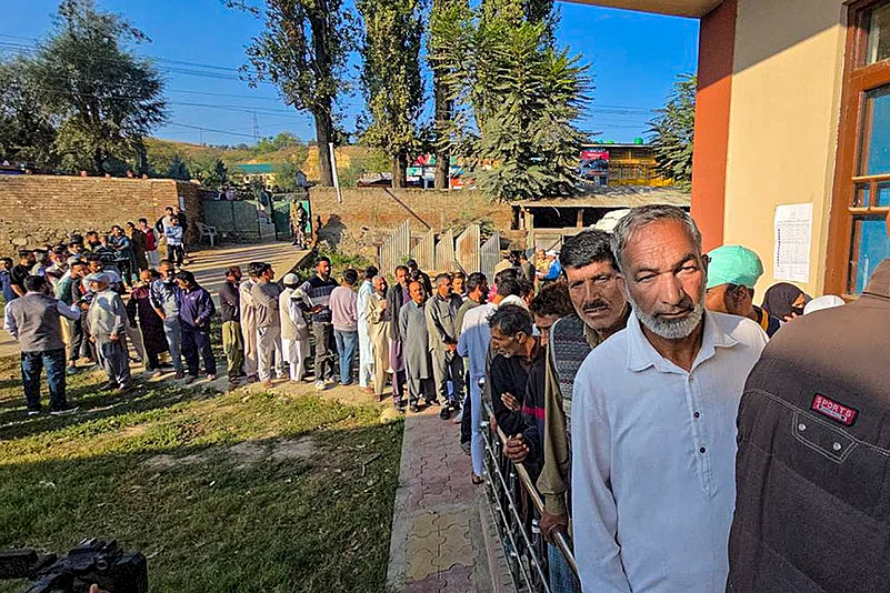 Voters wait in a queue
to vote during Jammu and Kashmir Assembly polls