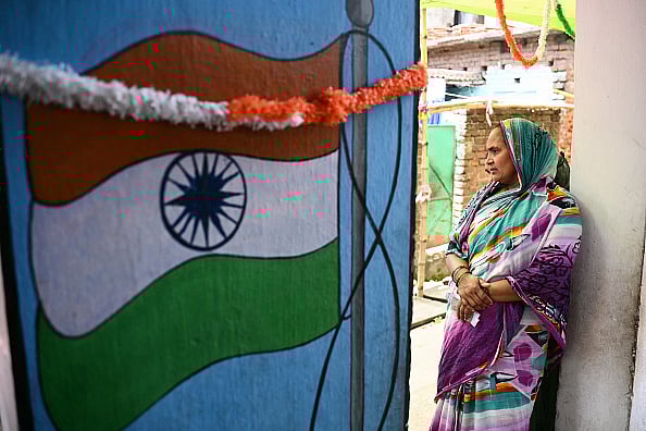 A voter waits to cast her ballot at a polling station during the sixth phase of voting in India's general election - Getty Images