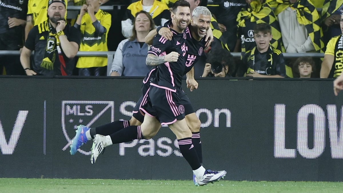 Lionel Messi (left) celebrates a goal with teammate Luis Suarez (Right). - AP