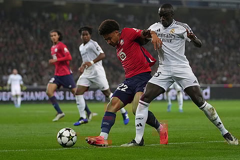 UCL 2024-25, Lille vs Real Madrid: Real Madrid's Ferland Mendy, right, and Lille's Tiago Santos vie for the ball
