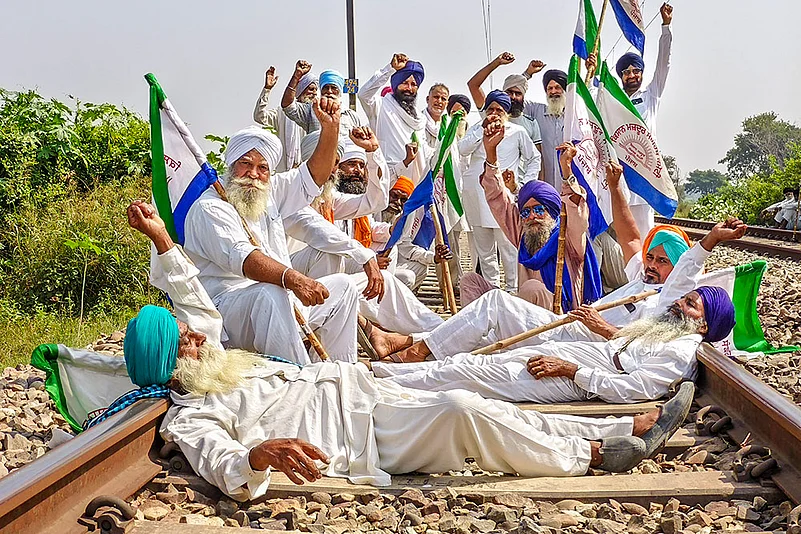 Farmers block a railway track during a protest in Amritsar