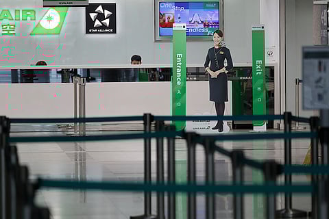 Taiwan Typhoon Krathon: Airline staff work at the counter at a closed airport