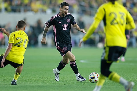 MLS Supporters' Shield, Columbus Crew vs Inter Miami: Inter Miami's Lionel Messi, center, tries to dribble between Columbus Crew's Alexandru Matan