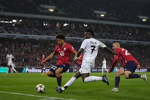 UCL 2024-25, Lille vs Real Madrid: Lille's Tiago Santos, left, challenges Real Madrid's Vinicius Junior