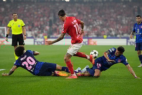 UCL 2024-25, Benfica vs Atletico Madrid: Benfica's Angel Di Maria, centre is tackled by Atletico Madrid's Axel Witsel, left, and Atletico Madrid's Nahuel Molina