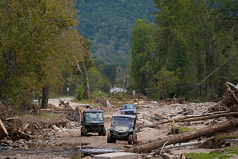 Hurricane Helene: Vehicles roll along on a washed up road