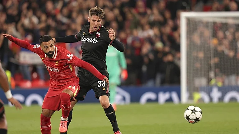 UCL 2024-25, Liverpool vs Bologna: Liverpool's Mohamed Salah, left, challenges for the ball with Bologna's Juan Miranda - | Photo: AP/Ian Hodgson