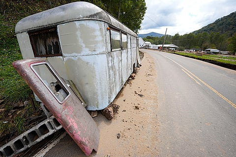Hurricane Helene: A trailer moved by floodwater sits on the side of a road