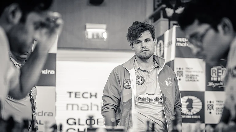 Magnus Carlsen (centre) watches Arjun Erigaisi (left) and R Praggnanandhaa intently during the Global Chess League in London. - Special Arrangement