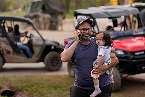 Hurricane Helene: A man makes a call on the wireless system set up at the volunteer fire station