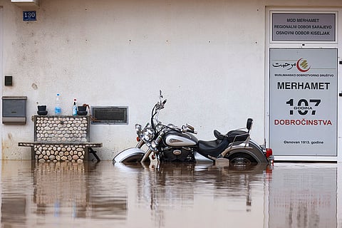 Bosnia Floods: A motorcycle is partially submerged in flood waters