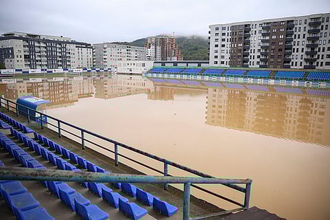 Bosnia Floods: Apartment buildings are reflected at a flooded soccer field