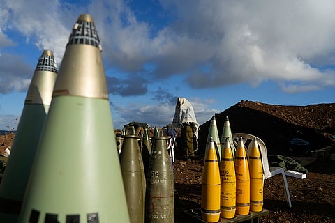 Mideast Tensions: An Israeli soldier covered in a prayer shawl prays at a mobile artillery position