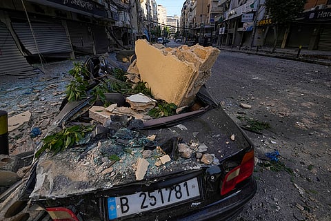 Mideast Tensions: A wrecked car parked next to the site of an Israeli airstrike in Beirut