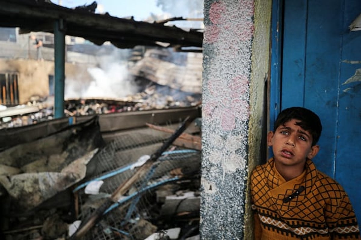 A Palestinian boy at the site of an Israeli strike on a school sheltering displaced people in Gaza.